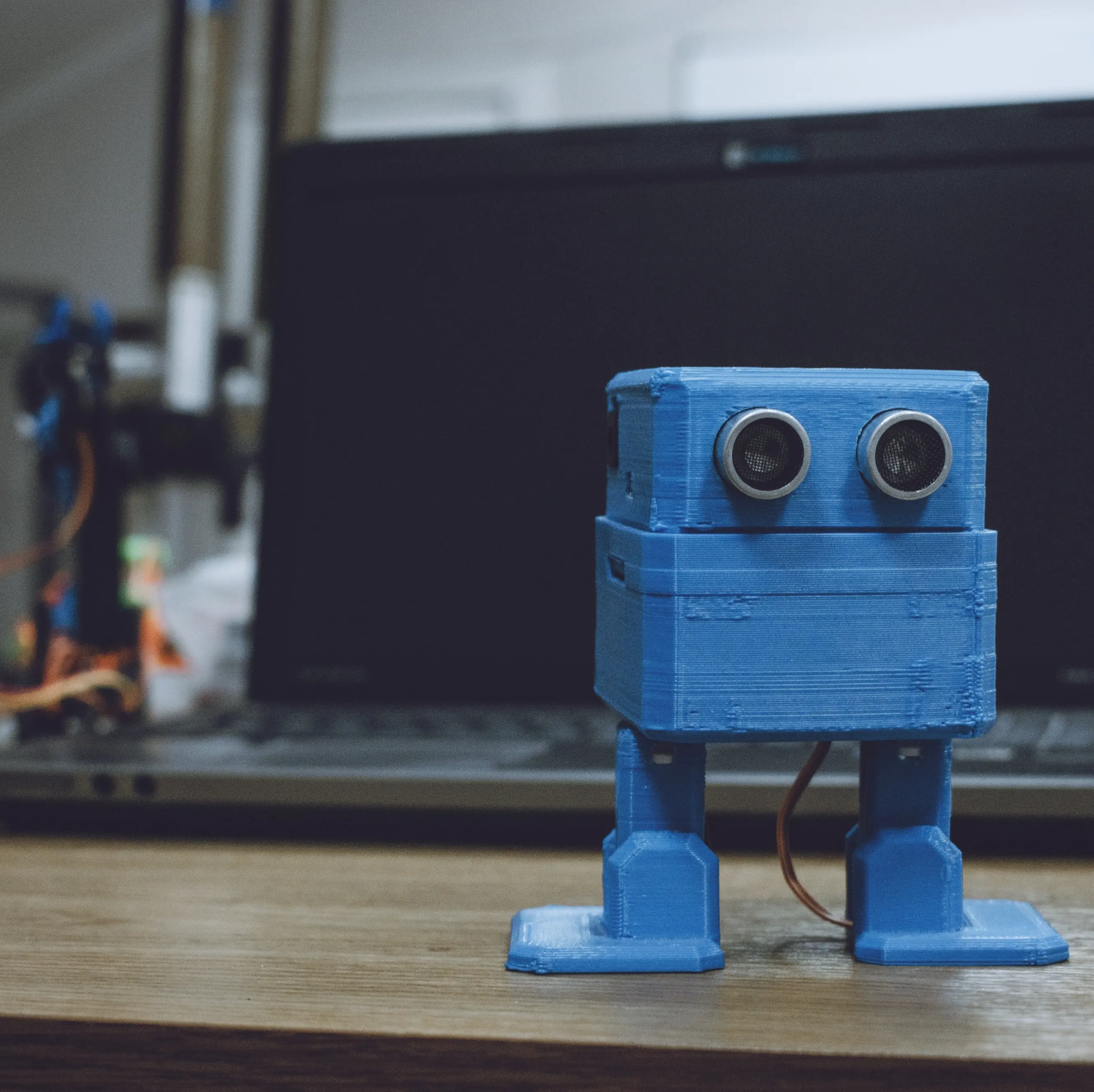 Small blue robot in front of laptop. Credit: @Irrmago via Twenty20